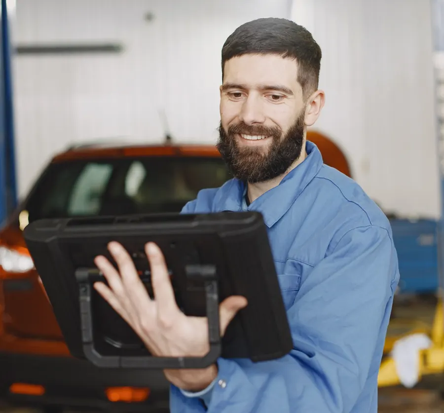 Portrait of a smiling technician holding a tablet